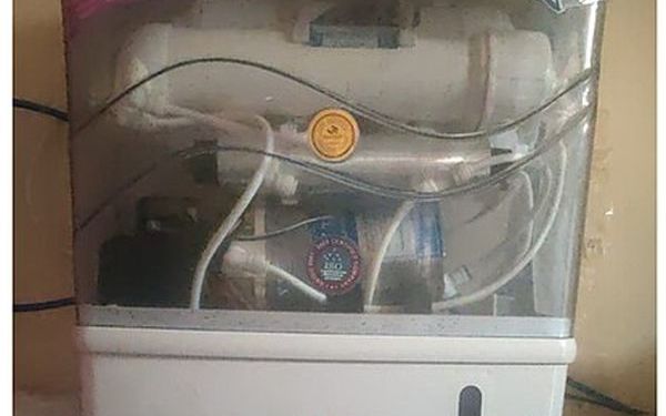 Domestic RO purifier cabinet with internal filter stages visible